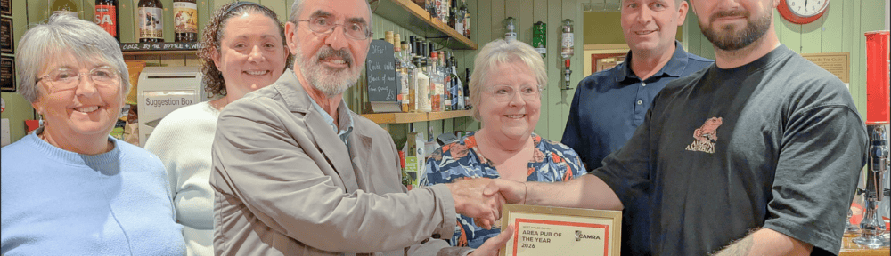 Y Cross Cas-Lai team receiving the CAMRA West Wales Pub of the Year certificate at the bar