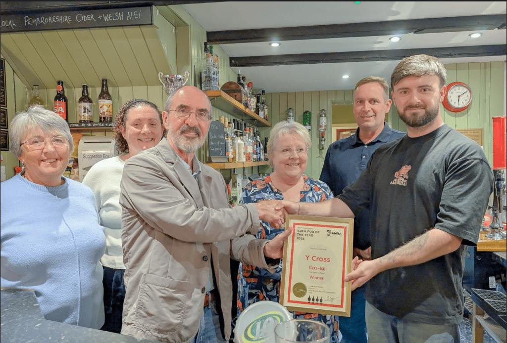 Y Cross Cas-Lai team receiving the CAMRA West Wales Pub of the Year certificate at the bar